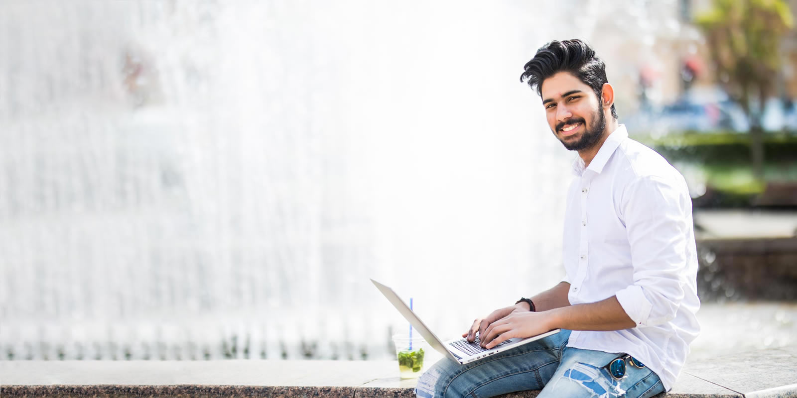 Young man on Laptop outside